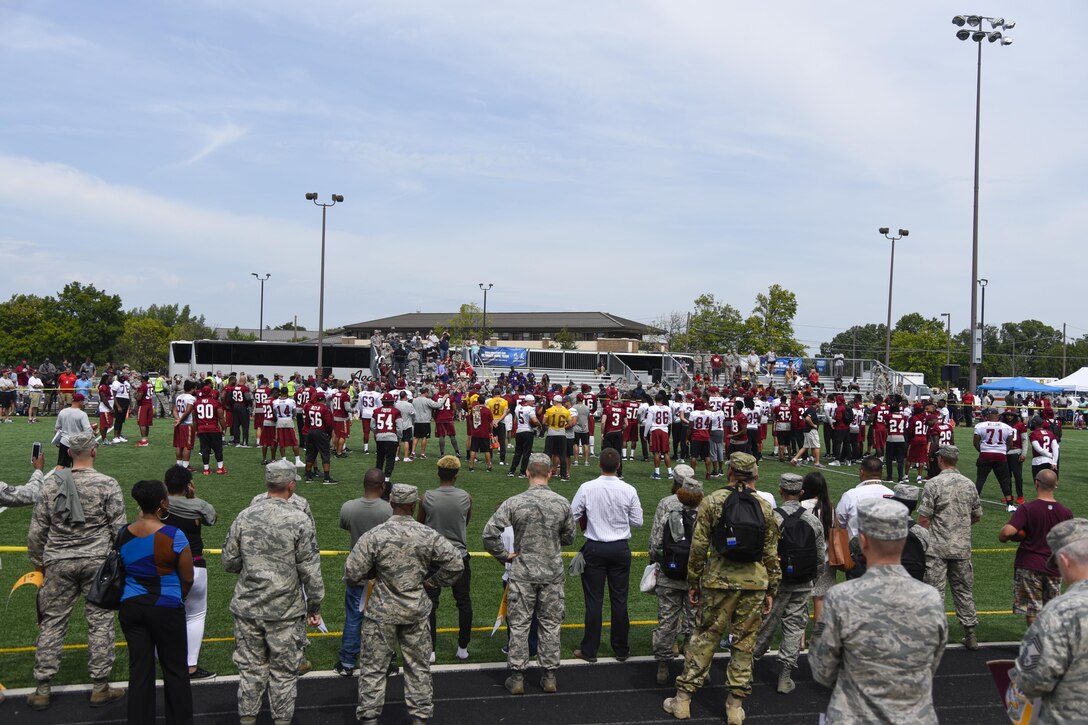 Members of Joint Base Andrews watch the Washington Redskins Pre-season Walk-through Practice at the West Fitness Center’s field on Joint Base Andrews, Md., Aug. 25, 2016. It was the fourth time the Redskins came to Joint Base Andrews in an effort to show their appreciation to the military community. (U.S. Air Force photo by Airman 1st Class Valentina Lopez)