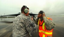 U.S. Air Force Chief Master Sgt. Melvina Smith, the 509th Bomb Wing command chief, (right) is instructed by Staff Sgt. Joshua Layton, a dedicated crew chief assigned to the 509th Aircraft Maintenance Squadron, on marshaling procedures at Andersen Air Force Base, Guam, Aug. 23, 2016. While visiting deployed Airmen from Whiteman Air Force Base, Mo., Smith experienced first-hand the routines crew chiefs perform while on the flightline. (U.S. Air Force photo by Senior Airman Jovan Banks)