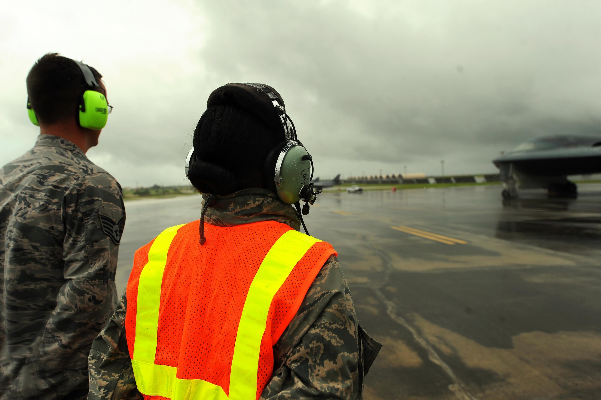 U.S. Air Force Chief Master Sgt. Melvina Smith, the 509th Bomb Wing command chief, (right) and Staff Sgt. Matthew Helms, a dedicated crew chief assigned to the 509th Aircraft Maintenance Squadron prepare to marshal a B-2 Spirit at Andersen Air Force Base, Guam, Aug. 23, 2016. While visiting deployed Airmen from Whiteman Air Force Base, Mo., Smith experienced first-hand the routines crew chiefs perform while on the flightline. (U.S. Air Force photo by Senior Airman Jovan Banks)