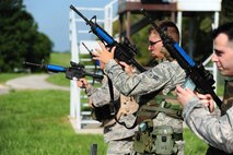 Airmen from the 509th Munitions Squadron practice rapid reloading before participating in shoot, move and communicate training at Whiteman Air Force Base, Mo., Aug. 18, 2016. The training consisted of basic shooting stances, reaction to fire, providing cover, and advancing positions all while engaging a simulated target. (U.S. Air Force photo by Senior Airman Joel Pfiester)
