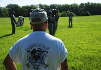 Tommy Hutfles, a 509th Security Forces Squadron instructor, watches as Airmen from the 509th Munitions Squadron (MUNS) participate in shoot, move and communicate training at Whiteman Air Force Base, Mo., Aug. 18, 2016. During the training, members of the 509th MUNS would pair up in teams of two, while providing cover fire and advance or fall back from their positions while firing their weapon at a target, suppressing a simulated enemy. (U.S. Air Force photo by Senior Airman Joel Pfiester)