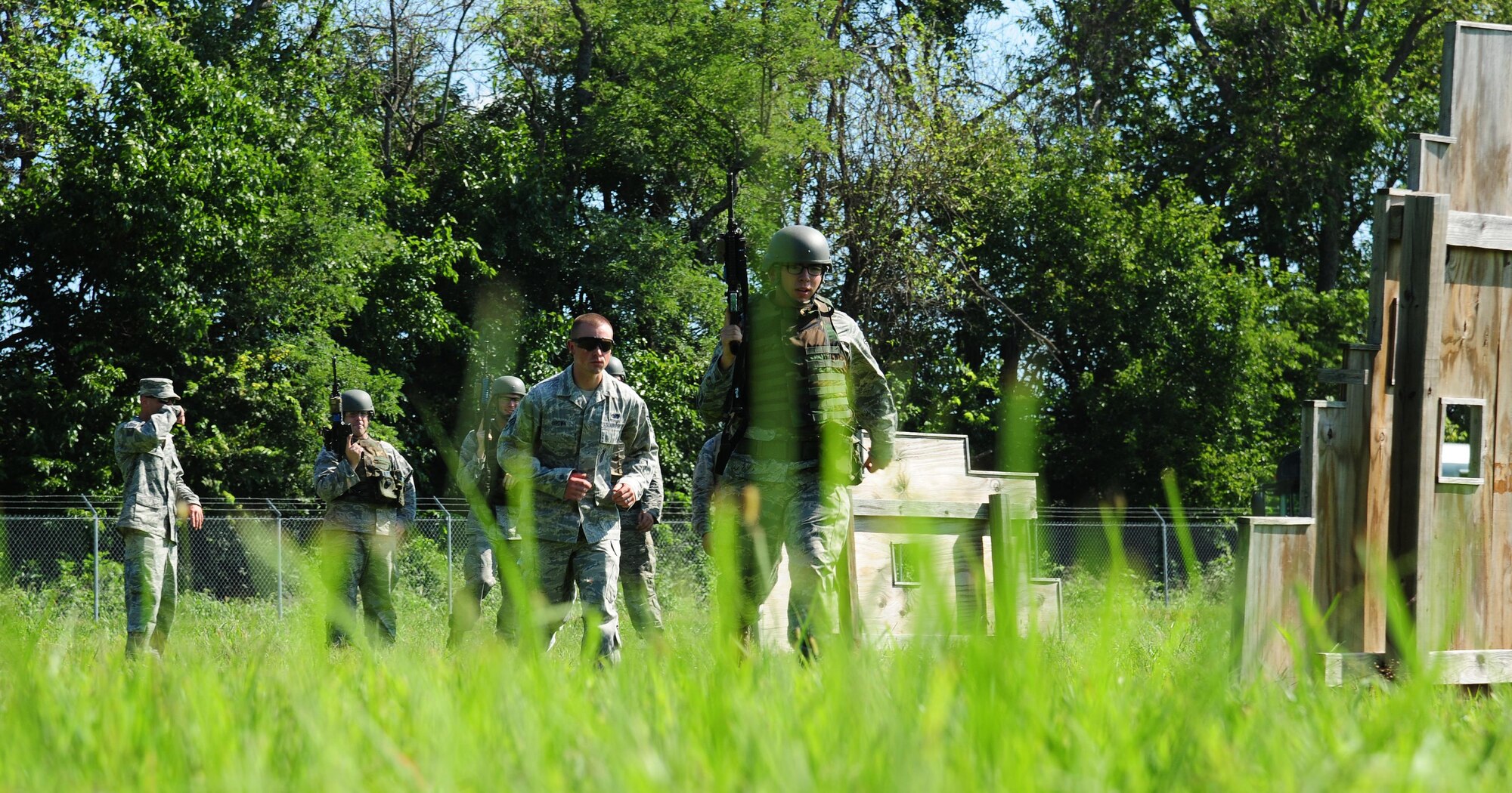 U.S. Air Force Airman 1st Class Joseph Buelt, a weapons team member from the 509th Munitions Squadron, moves to cover during shoot, move and communicate training at Whiteman Air Force Base, Mo., Aug. 16, 2016. The 509th Security Forces Squadron provided the training which gave insight on how to react to an enemy gaining entry into the weapons storage area. (U.S. Air Force photo by Senior Airman Joel Pfiester)