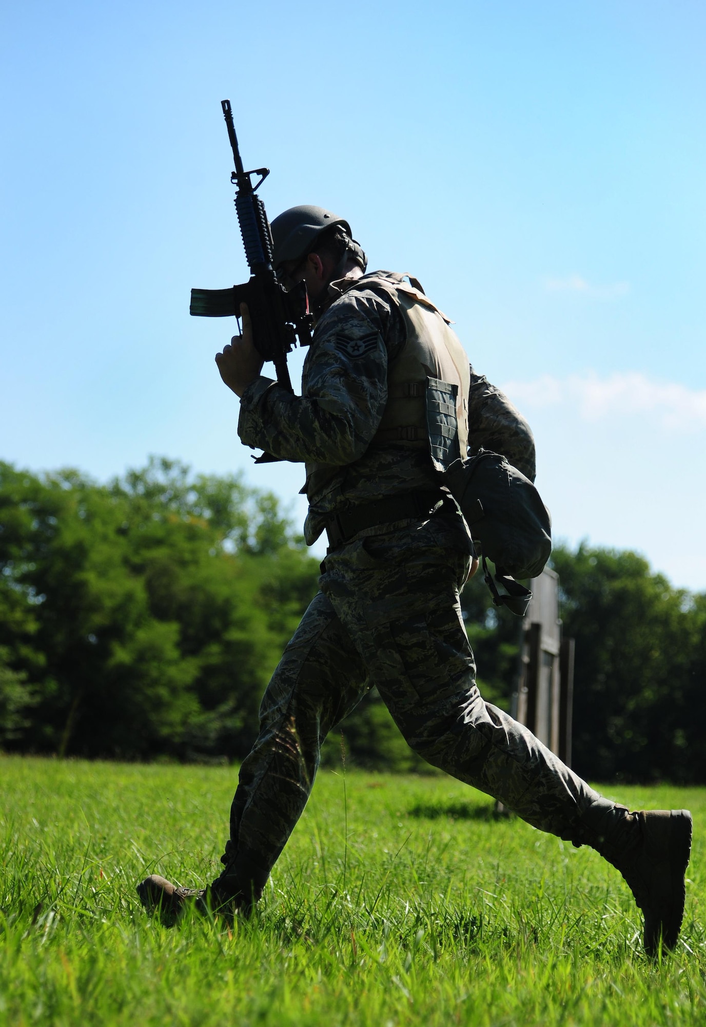 U.S. Air Force Staff Sgt. William Sines, a weapons team chief from the 509th Munitions Squadron, moves to cover during shoot, move and communicate training at Whiteman Air Force Base, Mo., Aug. 18, 2016. The training scenarios provided the Airmen with the basics of how to react during denial and recapture operations in real-world situations. (U.S. Air Force photo by Senior Airman Joel Pfiester)