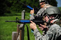 U.S. Air Force Senior Airman Michael Landley, a weapons team member from the 509th Munitions Squadron (MUNS), provides cover fire for Senior Airman Simon Joh, a weapons team member from the 509th MUNS, during shoot, move and communicate training at Whiteman Air Force Base, Mo., Aug. 18, 2016. During the training, Airmen used simulation rounds to engage targets. (U.S. Air Force photo by Senior Airman Joel Pfiester)