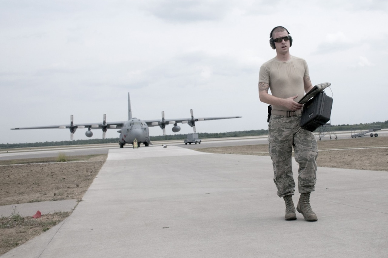 Air Force Senior Airman Zachary Allen, a flight equipment technician assigned to the 120th Airlift Wing, Montana Air National Guard, returns from post-flight-checking aircrew equipment aboard a C-130 Hercules cargo aircraft during Northern Strike Exercise 2016 in Alpena, Mich., Aug. 11, 2016. Air National Guard photo by Master Sgt. Leisa Grant