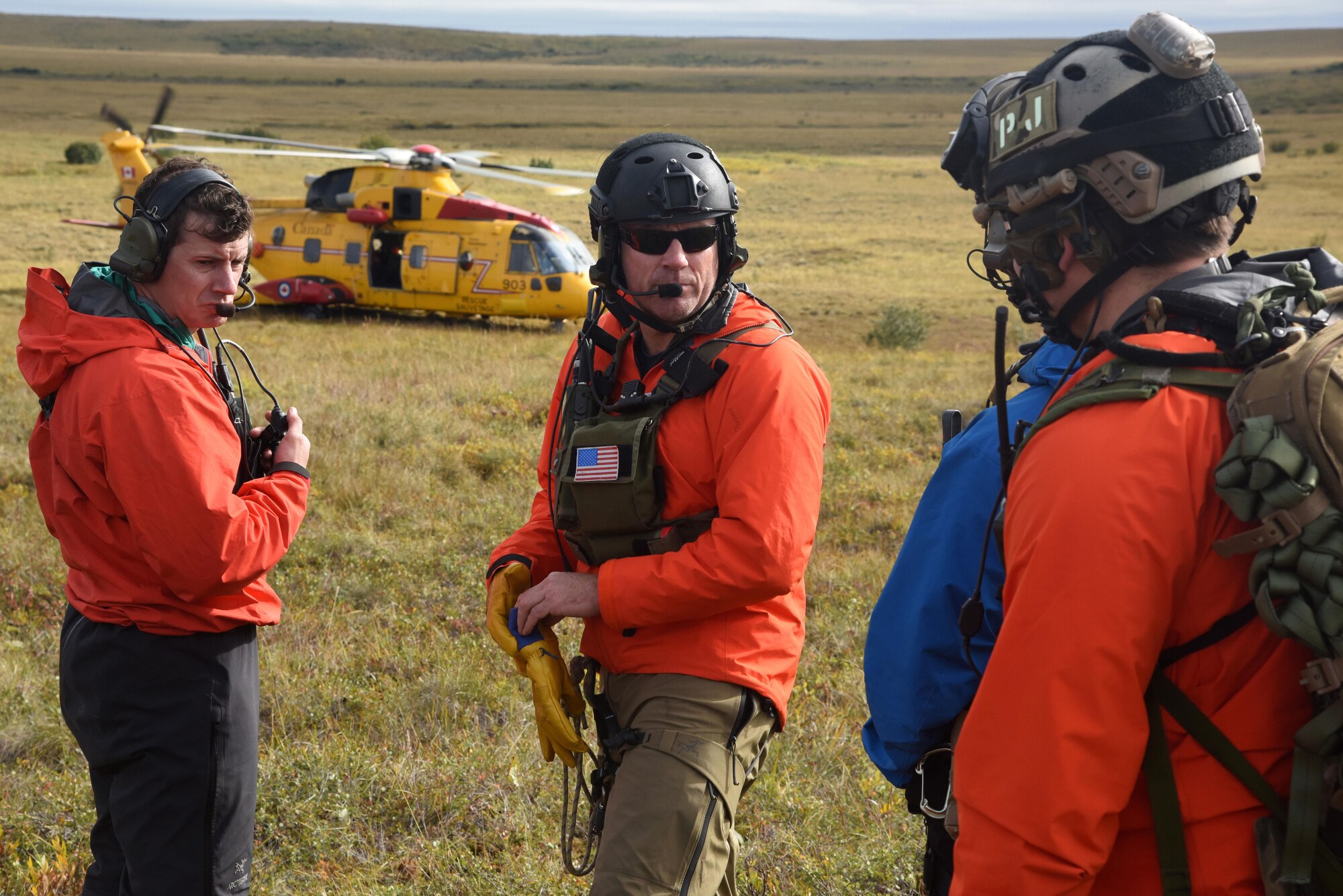 Pararescue jumpers with the 212th Rescue Squadron, Joint Base Elmendorf-Richardson, Alaska, discuss patient evacuation procedures during Exercise Arctic Chinook Aug. 24, 2016.  Exercise Arctic Chinook is a joint U.S. Coast Guard and U.S. Northern Command-sponsored exercise on the U.S. State Department approved list of Arctic Council Chairmanship events. The Arctic mass rescue operation exercise scenario consisted of an adventure-class cruise ship with approximately 200 passengers and crew that experience a catastrophic event with the need to abandon ship. Arctic Chinook exercised elements of the Arctic Search and Rescue Agreement to include interoperability, cooperation, information sharing, SAR services, and joint exercise review. 