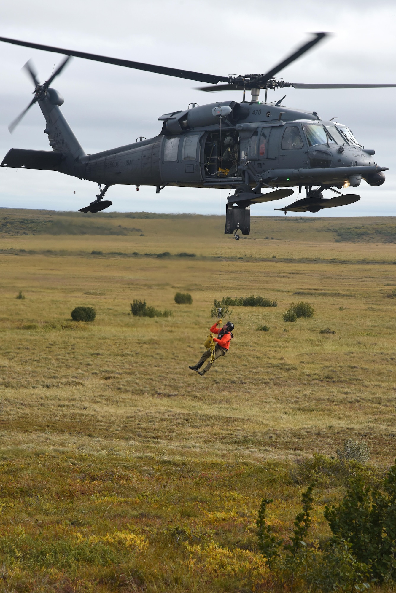 Technical Sgt. Cody Inman, a pararescueman with the 212th Rescue Squadron, Joint Base Elmendorf-Richardson, Alaska, is hoisted into a HH-60 Pavehawk helicopter during Exercise Arctic Chinook Aug. 24, 2016.  Exercise Arctic Chinook is a joint U.S. Coast Guard and U.S. Northern Command-sponsored exercise on the U.S. State Department approved list of Arctic Council Chairmanship events. The Arctic mass rescue operation exercise scenario consisted of an adventure-class cruise ship with approximately 200 passengers and crew that experience a catastrophic event with the need to abandon ship. Arctic Chinook exercised elements of the Arctic Search and Rescue Agreement to include interoperability, cooperation, information sharing, SAR services, and joint exercise review. 