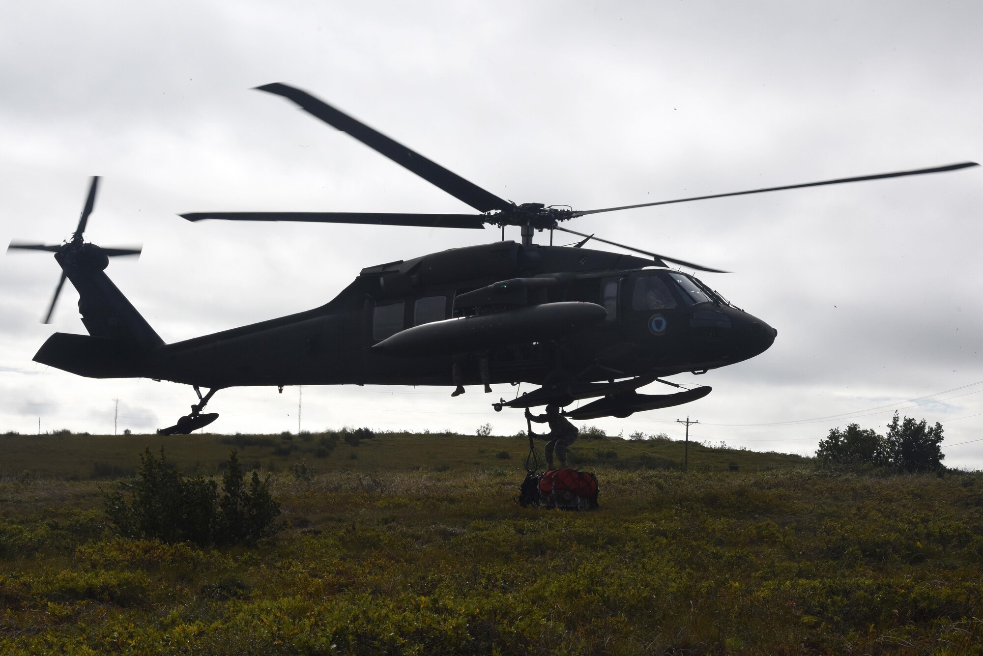 An Alaska Guard UH-60 Blackhawk helicopter picks up medical gear during Exercise Arctic Chinook Aug. 24, 2016.  Exercise Arctic Chinook is a joint U.S. Coast Guard and U.S. Northern Command-sponsored exercise on the U.S. State Department approved list of Arctic Council Chairmanship events. The Arctic mass rescue operation exercise scenario consisted of an adventure-class cruise ship with approximately 200 passengers and crew that experience a catastrophic event with the need to abandon ship. Arctic Chinook exercised elements of the Arctic Search and Rescue Agreement to include interoperability, cooperation, information sharing, SAR services, and joint exercise review. 