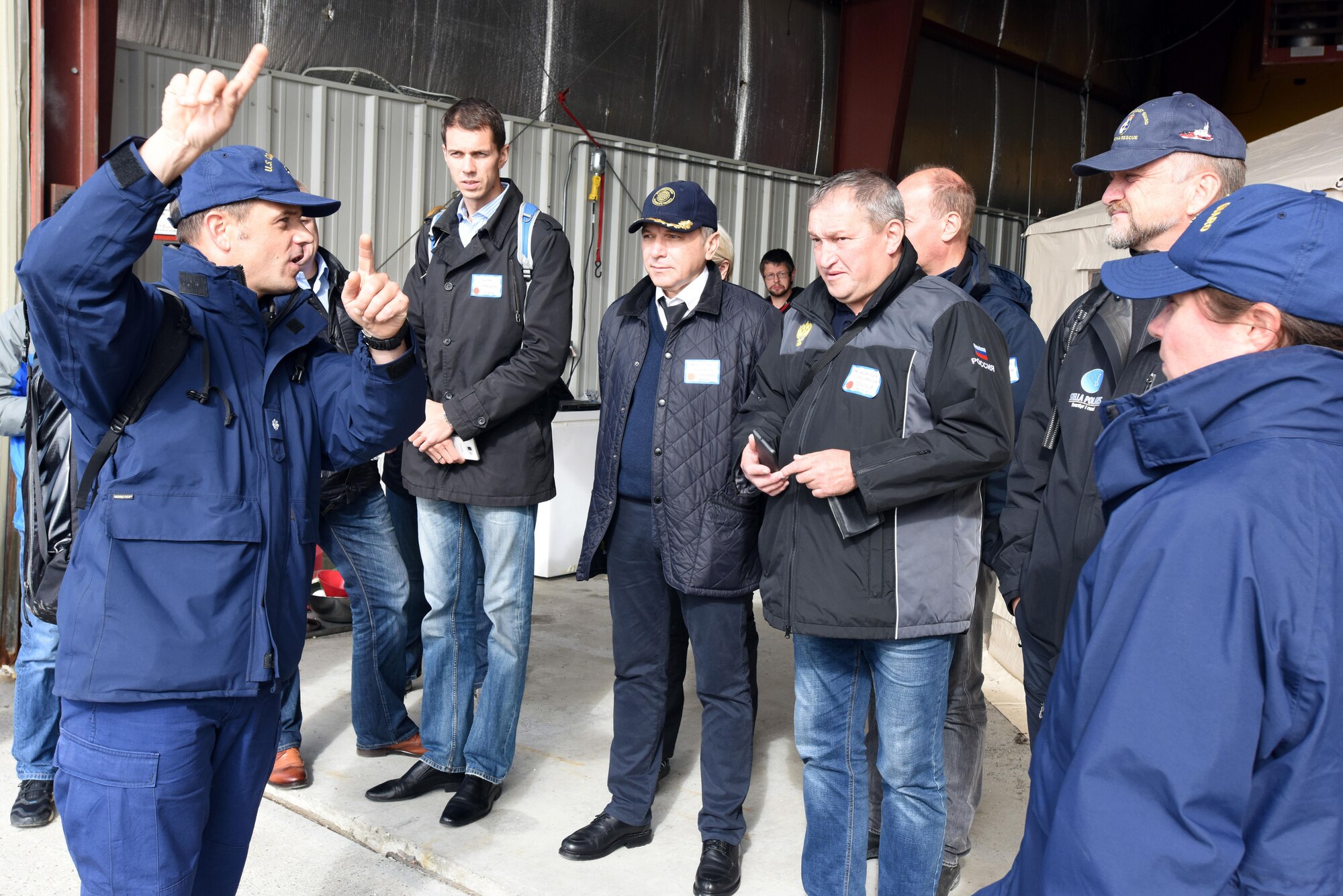 U.S. Coast Guard Cmdr Mark Wilcox, USCG District 17 Arctic operations coordinator, explains exercise details to Russian, Finish, Norwegian and Danish observers during Exercise Arctic Chinook Aug. 24, 2016.  Exercise Arctic Chinook is a joint U.S. Coast Guard and U.S. Northern Command-sponsored exercise on the U.S. State Department approved list of Arctic Council Chairmanship events. The Arctic mass rescue operation exercise scenario consisted of an adventure-class cruise ship with approximately 200 passengers and crew that experience a catastrophic event with the need to abandon ship. Arctic Chinook exercised elements of the Arctic Search and Rescue Agreement to include interoperability, cooperation, information sharing, SAR services, and joint exercise review.