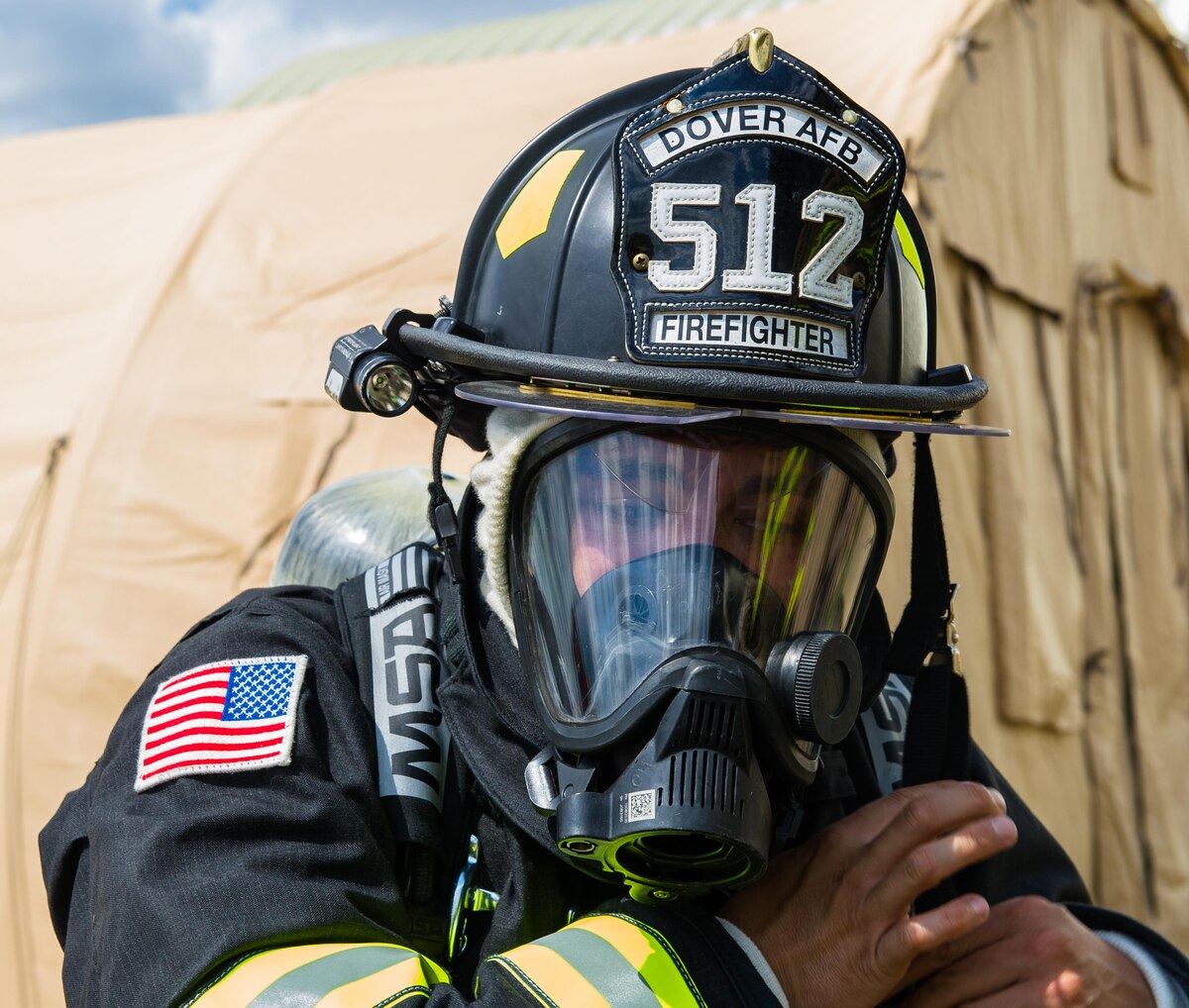 U.S. Air Force Senior Airman Rick Moralez, a firefighter from the 512th Civil Engineering Squadron, Dover Air Force Base, Del., prepares to enter a simulated tent fire at Tactical Assembly Area Young, Fort McCoy, Wis., August 16, 2016, during exercise Patriot Warrior. Patriot Warrior is the Air Force Reserve's premier contingency deployment training exercise, designed to demonstrate training ranging from bare base buildup to full operational capabilities. More than 11,000 members from the U.S. service branches and their Reserve components, including Air Force, Army, Navy, and Marines are participating alongside British, Canadian, and Saudi Arabian forces. (U.S. Air Force photo/Airman 1st Class Christopher Dyer)