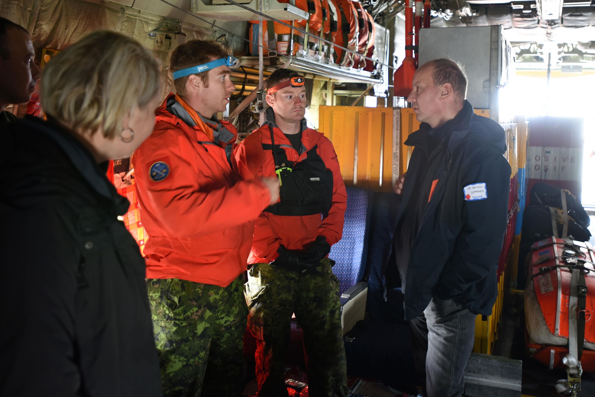 Royal Canadian Airmen discuss mass rescue operations and capabilities with Finland Border Guard Cmdr Petteri Leppanen during Exercise Arctic Chinook Aug. 24, 2016.  Leppanen is an observer of Exercise Arctic Chinook, which is a joint U.S. Coast Guard and U.S. Northern Command-sponsored exercise on the U.S. State Department approved list of Arctic Council Chairmanship events. The Arctic mass rescue operation exercise scenario consisted of an adventure-class cruise ship with approximately 200 passengers and crew that experience a catastrophic event with the need to abandon ship. Arctic Chinook exercised elements of the Arctic Search and Rescue Agreement to include interoperability, cooperation, information sharing, SAR services, and joint exercise review. 