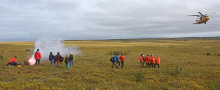 Pararescue jumpers with the 212th Rescue Squadron, Joint Base Elmendorf-Richardson, Alaska, pop smoke to signal a Royal Canadian Air Force helicopter to land in order to evacuate patients during Exercise Arctic Chinook Aug. 24, 2016.  Exercise Arctic Chinook is a joint U.S. Coast Guard and U.S. Northern Command-sponsored exercise on the U.S. State Department approved list of Arctic Council Chairmanship events. The Arctic mass rescue operation exercise scenario consisted of an adventure-class cruise ship with approximately 200 passengers and crew that experience a catastrophic event with the need to abandon ship. Arctic Chinook exercised elements of the Arctic Search and Rescue Agreement to include interoperability, cooperation, information sharing, SAR services, and joint exercise review. 