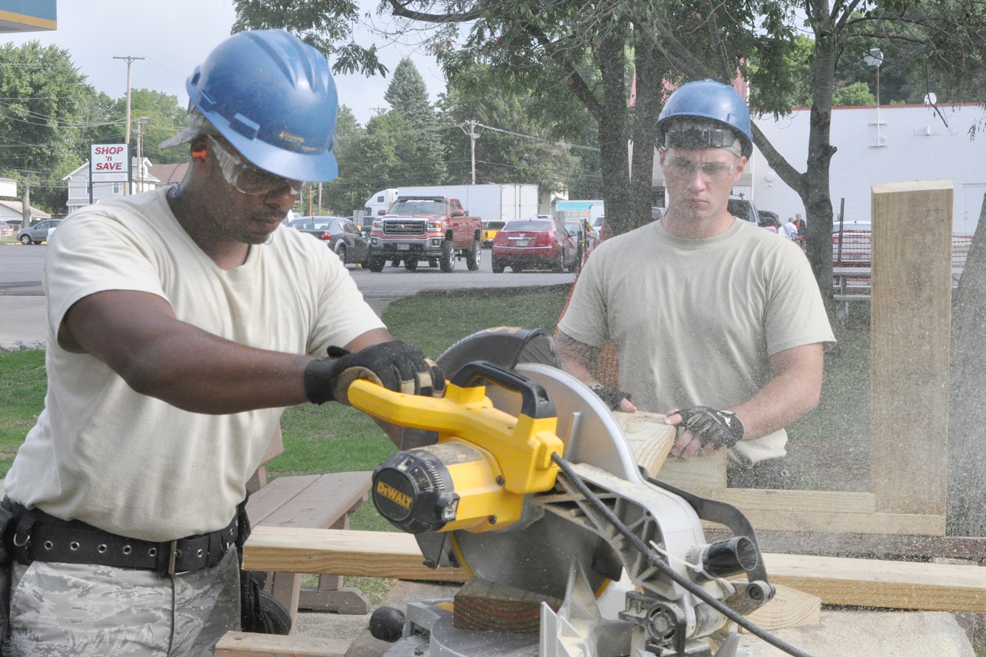 Senior Airman Charles Tazewell, a Civil Engineer structural engineer, uses a chop saw to cut a piece of treated lumber near the new staircase leading from the Veteran’s Park to the riverside here, Aug. 25, 2016. Tazewell is being assisted by Senior Airman Mike Dibble, also a Civil Engineer Structural Engineer, who is steadying the board as Tazewell cuts. Tazewell and Dibble are members of a small team from the 910th Civil Engineer Squadron, based at nearby Youngstown Air Reserve Station (YARS), Ohio, who teamed up with the City of Newton Falls to undertake a three-week project to demolish the existing staircase and design and build the new stairs under Department of Defense’s Realistic Military Training program and the Air Force Community Partnership Program. The program is designed to identify and develop mutually beneficial partnerships between Air Force installations and surrounding communities. (U.S. Air Force photo/Master Sgt. Bob Barko Jr.)