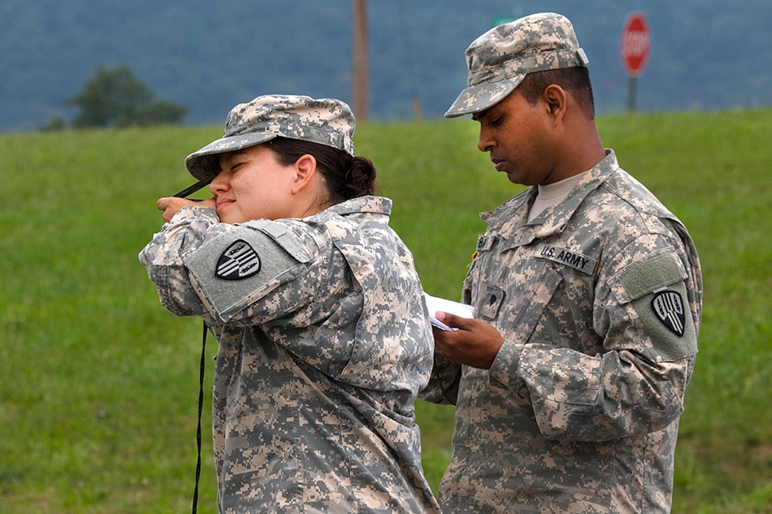 A soldier uses a compass during premobilization training at Fort Indiantown Gap, Pa., Aug. 16, 2016. Army National Guard photo by Sgt. Cesar Leon