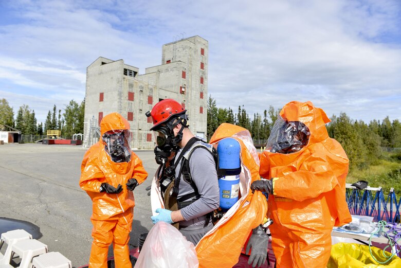 U.S. Army Staff Sgt. Andrew Markham, an Alaska Army National Guard Chemical, Biological, Radiological and Nuclear noncommissioned officer assigned to the 103rd Weapons of Mass Destruction-Civil Support Team out of Kulis Air National Guard Base, Alaska, goes through a chemical decontamination point during an exercise Aug. 23, 2016, at the Fairbanks Regional Fire Training Center in Fairbanks, Alaska. During  the exercise, participants had to be decontaminated before leaving a contaminated area, known as the hot zone. (U.S. Air Force photo by Airman Isaac Johnson)
