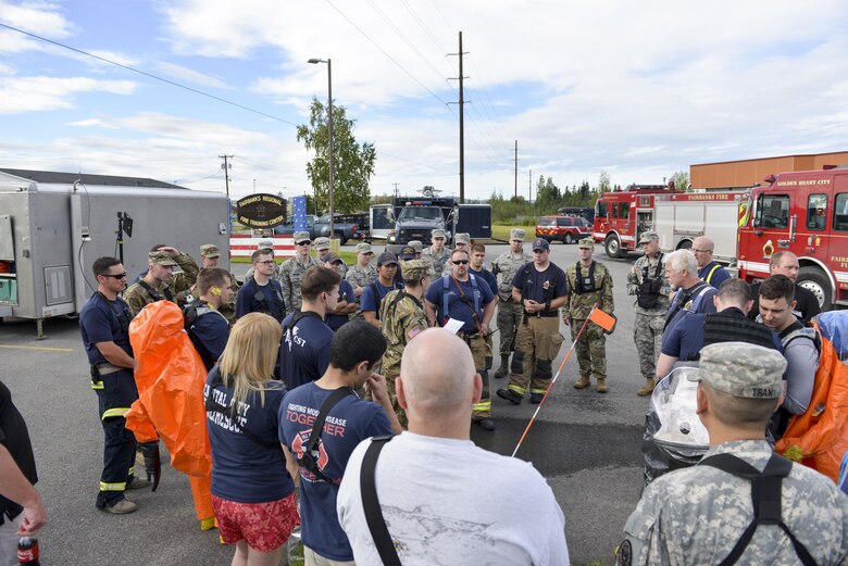 U.S. military and civilian participants of a Chemical, Biological, Radiological, Nuclear and Environmental exercise receive a briefing on a scenario they will participate in Aug. 23, 2016, at the Fairbanks Regional Fire Training Center in Fairbanks, Alaska. Members of the 354th Civil Engineer Squadron, 103rd Weapons of Mass Destruction-Civil Support Team, Fairbanks Fire Department, and the FBI participated in the exercise. (U.S. Air Force photo by Airman Isaac Johnson)
