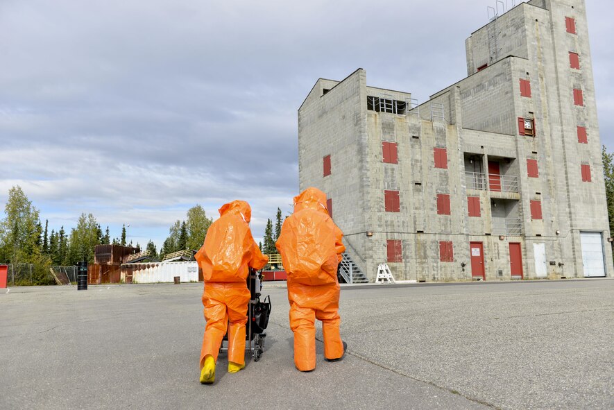 U.S. Air Force Senior Airman Eric McComb and U.S. Army Staff Sgt. Andrew Markham, both Chemical, Biological, Radiological and Nuclear (CBRN) technicians with the 103rd Weapons of Mass Destruction-Civil Support Team (WMD-CST), out of Kulis Air National Guard Base, Alaska, walk toward a building with potential CBRN threats Aug. 23, 2016, at the Fairbanks Regional Fire Training Center in Fairbanks, Alaska. The 103rd WMD-CST is a joint unit thats includes both Alaska Air National Guard and Alaska Army National Guard. (U.S. Air Force photo by Airman Isaac Johnson)
