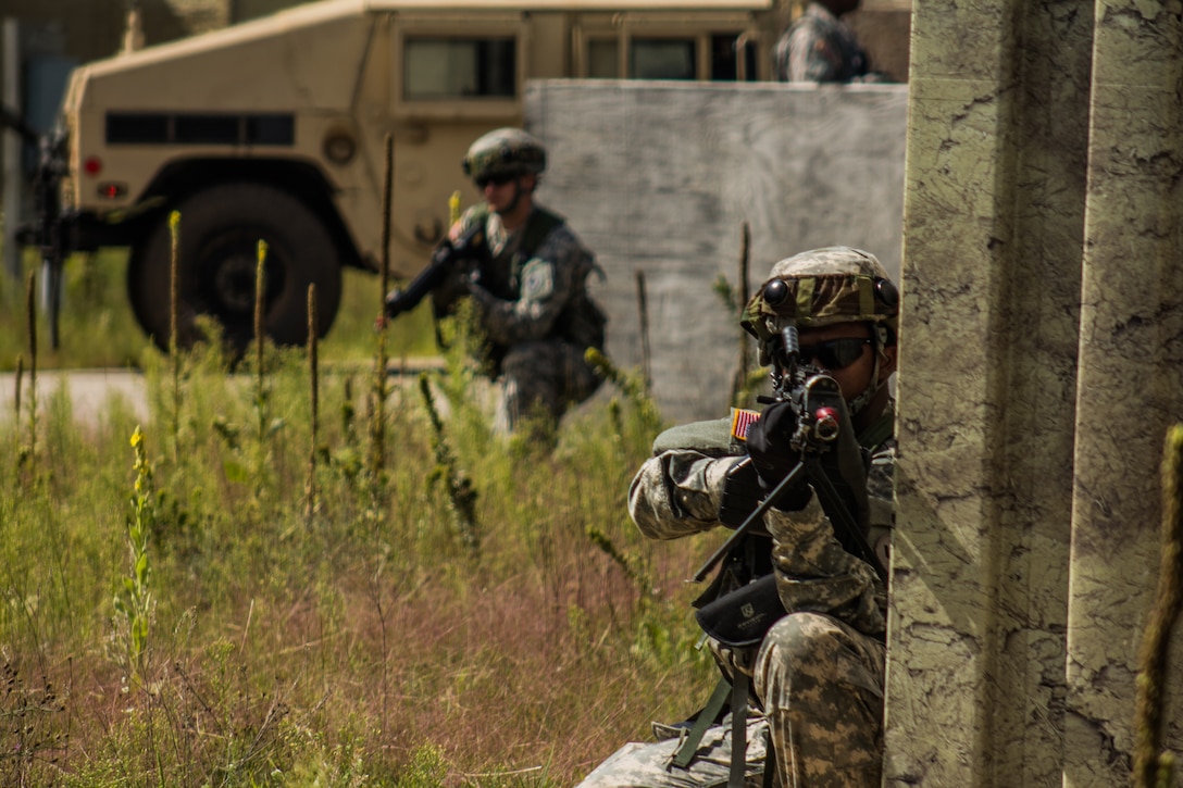 FORT MCCOY, WIS. – U.S. Army Reserve Soldier, Spc. Kevin Hanks (right), with the 459th Transportation Company from Elwood, Ill., pulls security after his convoy is halted by a mock improvised explosive device while delivering humanitarian aid supplies Aug 21, 2016 during an exercise at Fort McCoy, Wis. (U.S. Army Reserve photo by Sgt. Clinton Massey, 206th Broadcast Operations Detachment)