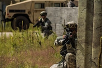 FORT MCCOY, WIS. – U.S. Army Reserve Soldier, Spc. Kevin Hanks (right), with the 459th Transportation Company from Elwood, Ill., pulls security after his convoy is halted by a mock improvised explosive device while delivering humanitarian aid supplies Aug 21, 2016 during an exercise at Fort McCoy, Wis. (U.S. Army Reserve photo by Sgt. Clinton Massey, 206th Broadcast Operations Detachment)