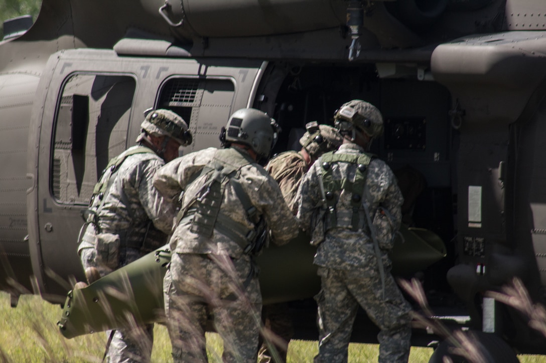 FORT MCCOY, Wis. – U.S. Army Reserve Soldiers, with the 459th Transportation Company from Elwood, Ill., load a victim of an oppositional forces attack, into a UH-60 Black Hawk medical evacuation helicopter, during a combat support training exercise, at Fort McCoy, Wis., Aug. 21, 2016. (U.S. Army Reserve photo by Sgt. Clinton Massey, 206th Broadcast Operations Detachment)