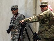 FORT MCCOY, Wis. – U.S. Army Reserve Soldiers, Staff Sgt. Robert Statum (right), with the 206th Broadcast Operations Detachment from Grand Prairie, Texas, and Spc. Christopher Hernandez, with the 345th Mobile Public Affairs Detachment from San Antonio, Texas, stand ready to capture footage of a combat support training exercise Aug. 21, 2016 at Fort McCoy, Wis. Exercise News Day provides public affairs support during annual training events, like combat support training exercise, throughout the U.S. Army Reserve.  (U.S. Army Reserve photo by Sgt. Clinton Massey, 206th Broadcast Operations Detachment)