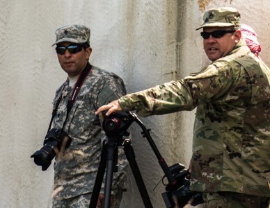 FORT MCCOY, Wis. – U.S. Army Reserve Soldiers, Staff Sgt. Robert Statum (right), with the 206th Broadcast Operations Detachment from Grand Prairie, Texas, and Spc. Christopher Hernandez, with the 345th Mobile Public Affairs Detachment from San Antonio, Texas, stand ready to capture footage of a combat support training exercise Aug. 21, 2016 at Fort McCoy, Wis. Exercise News Day provides public affairs support during annual training events, like combat support training exercise, throughout the U.S. Army Reserve.  (U.S. Army Reserve photo by Sgt. Clinton Massey, 206th Broadcast Operations Detachment)