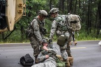 FORT MCCOY, Wis. – U.S. Army Reserve Soldiers, with the 397th Engineering Battalion from Eau Claire, Wis., pull a victim of a mock roadside attack to safety. U.S. Army Reserve medic, Pfc. Gage Theisen (right) administers first-aid and prepares victims for medical evacuation during a combat support training exercise Aug. 20, 2016 at Fort McCoy, Wis. (U.S. Army Reserve photo by Sgt. Clinton Massey, 206th Broadcast Operations Detachment)