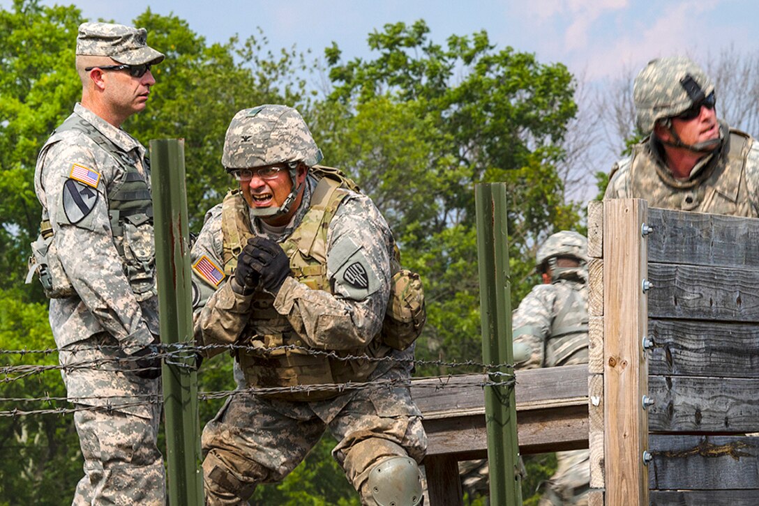 Army Col. David Martinez, commander, New York Army National Guard’s 369th Sustainment Brigade, prepares to throw a training grenade during premobilization training at Fort Indiantown Gap, Pa., Aug. 16, 2016. Army National Guard photo by Sgt. Cesar Leon