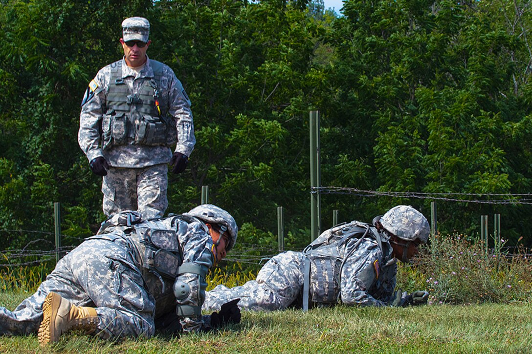 Soldiers crawl under a wire obstacle during premobilization training at Fort Indiantown Gap, Pa., Aug. 16, 2016. Army National Guard photo by Sgt. Cesar Leon
