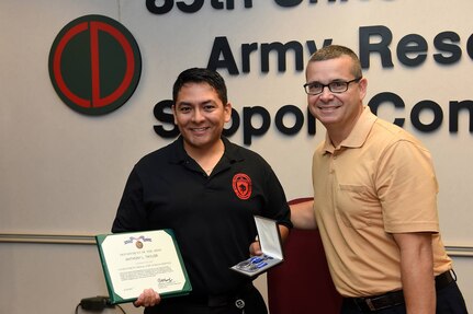 Mr. Anthony L. Taylor, left, Public Affairs Specialist, 85th Support Command, and Mr. Robert Spinelli, Civilian Executive Officer, 85th Support Command, pause for a photo after Taylor receives an Achievement Medal for Civilian Service. Taylor was one of several civilians recognized for their contributions to the command and Army Reserve.
(Photo by Spc. David Lietz)