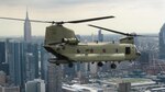 A South Carolina Army National Guard (SCARNG) CH-47F Chinook helicopter flies on the Hudson River, in proximity of Manhattan and Empire State Building, Aug. 18, 2016, over New York City. The helicopter escorted its predecessor, CH-47D "Guard Copter 368" during its last mission. 