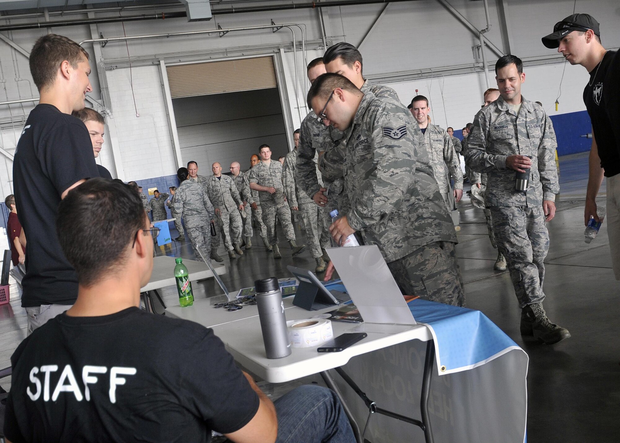 Airmen walk into the Bennie Davis Maintenance Facility’s Dock 1 for the first official Make Offutt Better function Aug. 19 at Offutt Air Force Base, Neb.  The Make Offutt Better initiative is comprised of a variety of clubs made up by both Airmen and civilian base populace.  (U.S. Air Force photo by Jeff Gates/Released)