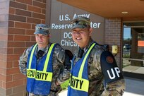 Army Reserve Spc. Christopher Merrell, left, Human Resources Specialist, and Staff Sgt. Dave Mercado, Physical Security Officer, pause for a photo during a security patrol at the command headquarters, Aug. 7, 2016. Random Access Measures have elevated here to further ensure the safety of civilian staff and service members assigned.
(Photo by Spc. David Lietz)