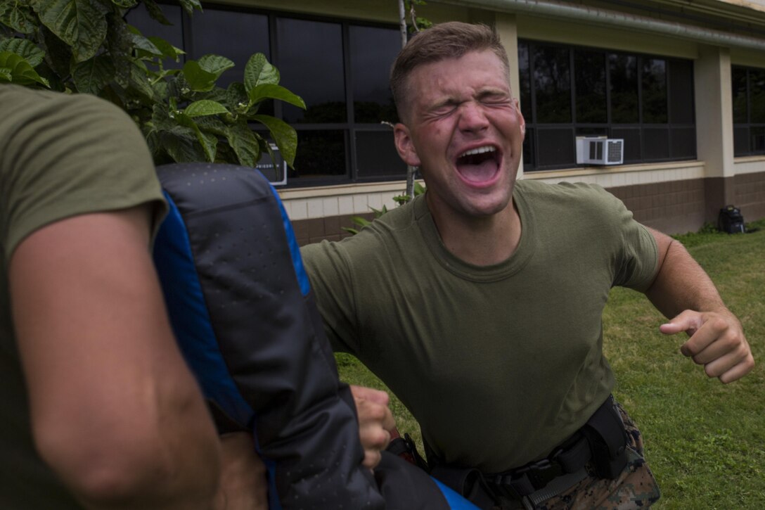 MARINE CORPS BASE HAWAII – Lance Cpl. Robert Patrick, an airframe mechanic with Marine Aviation Logistics Squadron 24, and a Cumming, Ga., native, performs an elbow strike as part of a defensive and offensive tactics course near the Provost Marshal’s Office aboard Marine Corps Base Hawaii, Aug. 18, 2016. Marines from various units are undergoing a two-week training course to support the PMO as part of the Gate Augmentation Force.  One of the training requirements necessary for completing the program, service members must conduct defensive and offensive tactics in response to a simulated attack after having been pepper sprayed.  Instructors exposed the service members to the spray in order to reinforce the importance of remaining calm, should they be contaminated by it in the future.  (U.S. Marine Corps photo by Lance Cpl. Jesus Sepulveda Torres)