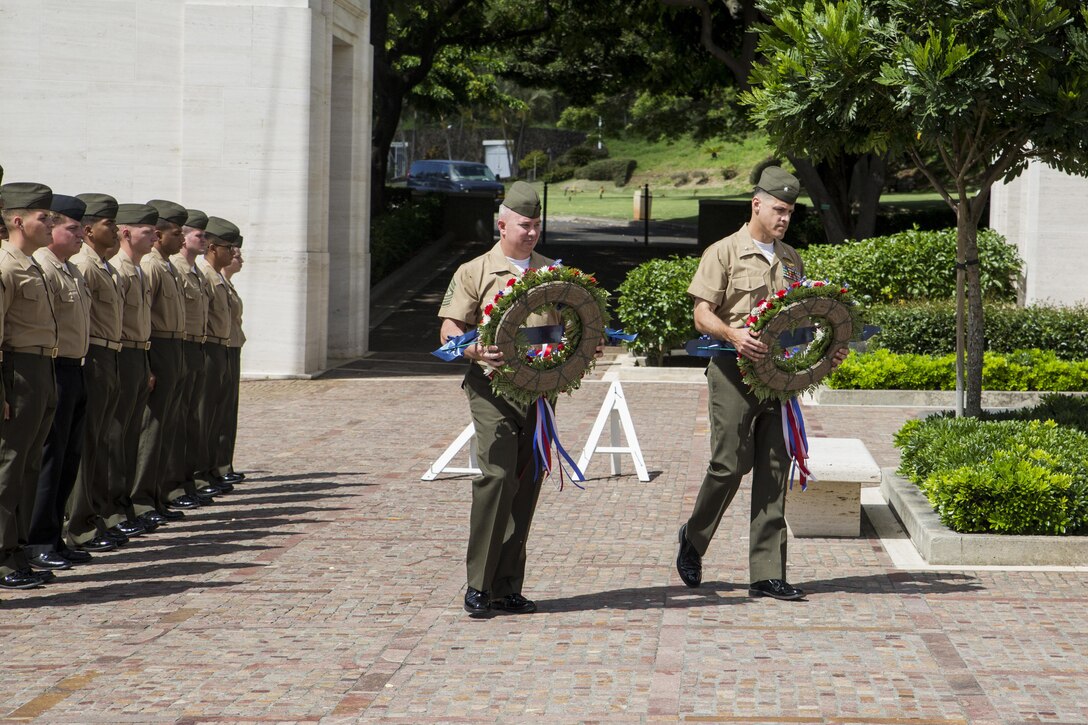 HONOLULU — Sgt. Maj. Daniel Moore, the sergeant major for Marine Fighter Attack Squadron 115, “Silver Eagles,” and a Beaufort, S.C., native, alongside Lt. Col. Shannon Brown, the commanding officer of VMFA-115, and a Columbus, Ohio, native, carry wreaths during a memorial ceremony at the National Memorial Cemetery of the Pacific in Honolulu, July 29, 2016. Marines paid tribute to 1st Lt. Jack Aldrich, the first pilot killed from that squadron. With a long history of participating in almost every major conflict since their formation 73 years ago, VMFA-115 honored their fallen comrade. Marines from VMFA-115, stationed aboard Marine Corps Air Station Beaufort, S.C., were in Hawaii participating in the 2016 Rim of Pacific exercise, the largest maritime exercise in the world. Between aircraft maintenance and training, Marines remembered the legacy of Aldrich. (Marine Corps Photo by Lance Cpl. Jesus Sepulveda Torres)