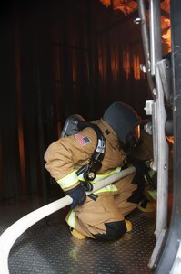 Sailors from Naval Submarine Training Center (NSTCP) detachment (det) Guam demonstrate the new Mobile Trainer 1000 submarine firefighting trainer after a ribbon cutting ceremony on Polaris Point, Guam, Aug. 26, 2016.  NSTCP det Guam provides training for the four Los Angeles-class attack submarines based out of Apra Harbor, Guam, and submarines deployed throughout the Pacific Ocean.