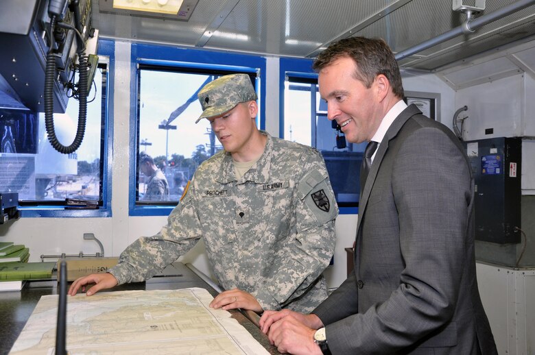 Secretary of the Army Eric Fanning looks at a navigational chart with Spc. Bruce Pritchard, the leading seaman for the U.S. Army Vessel Aldie (LCU-2004), a landing craft utility vessel, during a 97th Transportation Company tour at 7th Transportation Brigade (Expeditionary) at Joint Base Langley-Eustis, Virginia, Aug. 25, 2016. (U.S. Army photo by Stephanie Slater)