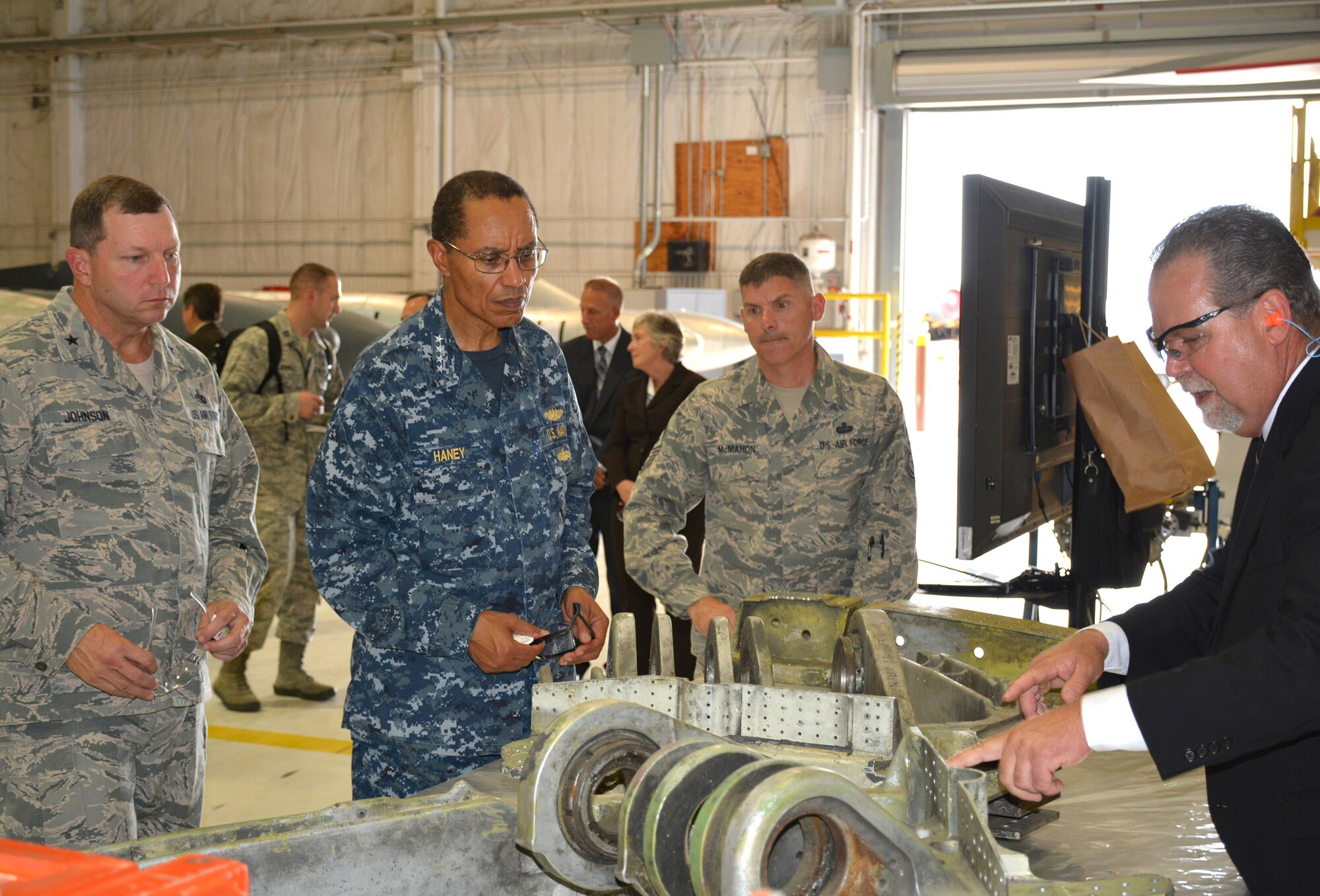 Charles Alley, 565th Aircraft Maintenance Squadron director, right, explains the areas where cracks that lead to the need to replace lower segment halves in the B-52 landing gear are typically found to Adm. Cecil Haney, commander, U.S. Strategic Command, during a visit to Bldg. 2121 on Aug. 12. The stop in Bldg. 2121 was just one of many Admiral Haney and his senior enlisted leader, Chief Master Sgt. Patrick McMahon, second from right, made as part of their visit to the Navy’s Strategic Communications Wing ONE and Tinker Air Force Base. Also looking on is Brig. Gen. Mark Johnson, left, Oklahoma City Air Logistics Complex commander. (Air Force photo by Darren D. Heusel)