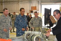 Charles Alley, 565th Aircraft Maintenance Squadron director, right, explains the areas where cracks that lead to the need to replace lower segment halves in the B-52 landing gear are typically found to Adm. Cecil Haney, commander, U.S. Strategic Command, during a visit to Bldg. 2121 on Aug. 12. The stop in Bldg. 2121 was just one of many Admiral Haney and his senior enlisted leader, Chief Master Sgt. Patrick McMahon, second from right, made as part of their visit to the Navy’s Strategic Communications Wing ONE and Tinker Air Force Base. Also looking on is Brig. Gen. Mark Johnson, left, Oklahoma City Air Logistics Complex commander. (Air Force photo by Darren D. Heusel)