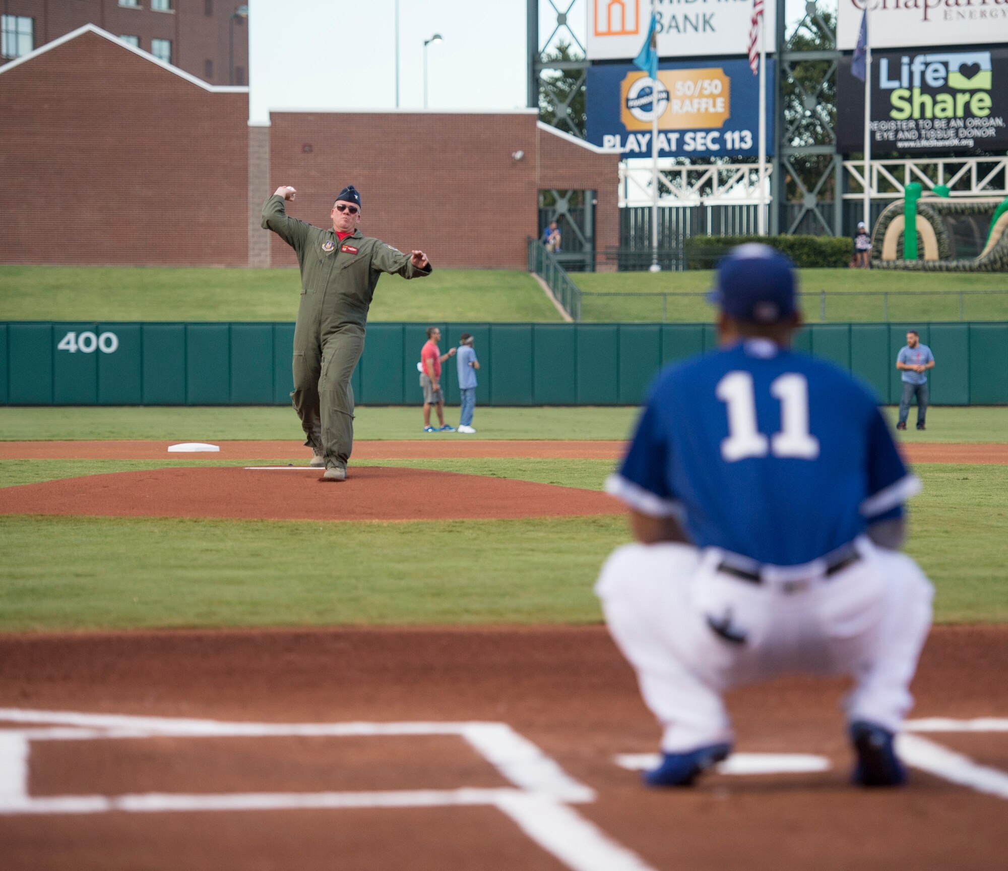 Col. David Robertson, the 513th Air Control Group commander, throws the first pitch Aug. 19 at Chickasaw Bricktown Ballpark in Oklahoma City as part of the Oklahoma City Dodgers military celebration night. The military-themed evening also included a mass re-enlistment and the Tinker Air Force Base Honor Guard.  (Air Force photo by 2nd Lt. Caleb Wanzer)