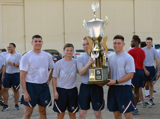 Col. Eric Shafa, 42nd Air Base Wing commander, presents a trophy to members of the 42nd Medical Group during the commander’s challenge on Maxwell Air Force Base, Ala., Aug. 26, 2016. Shafa created the commander’s challenge as an opportunity for the units within the 42nd ABW to work together and build comradery. The 42nd MDG finished first with a time of 12.17 while participating in the two-mile challenge. (U.S. Air Force photo/Senior Airman Tammie Ramsouer)