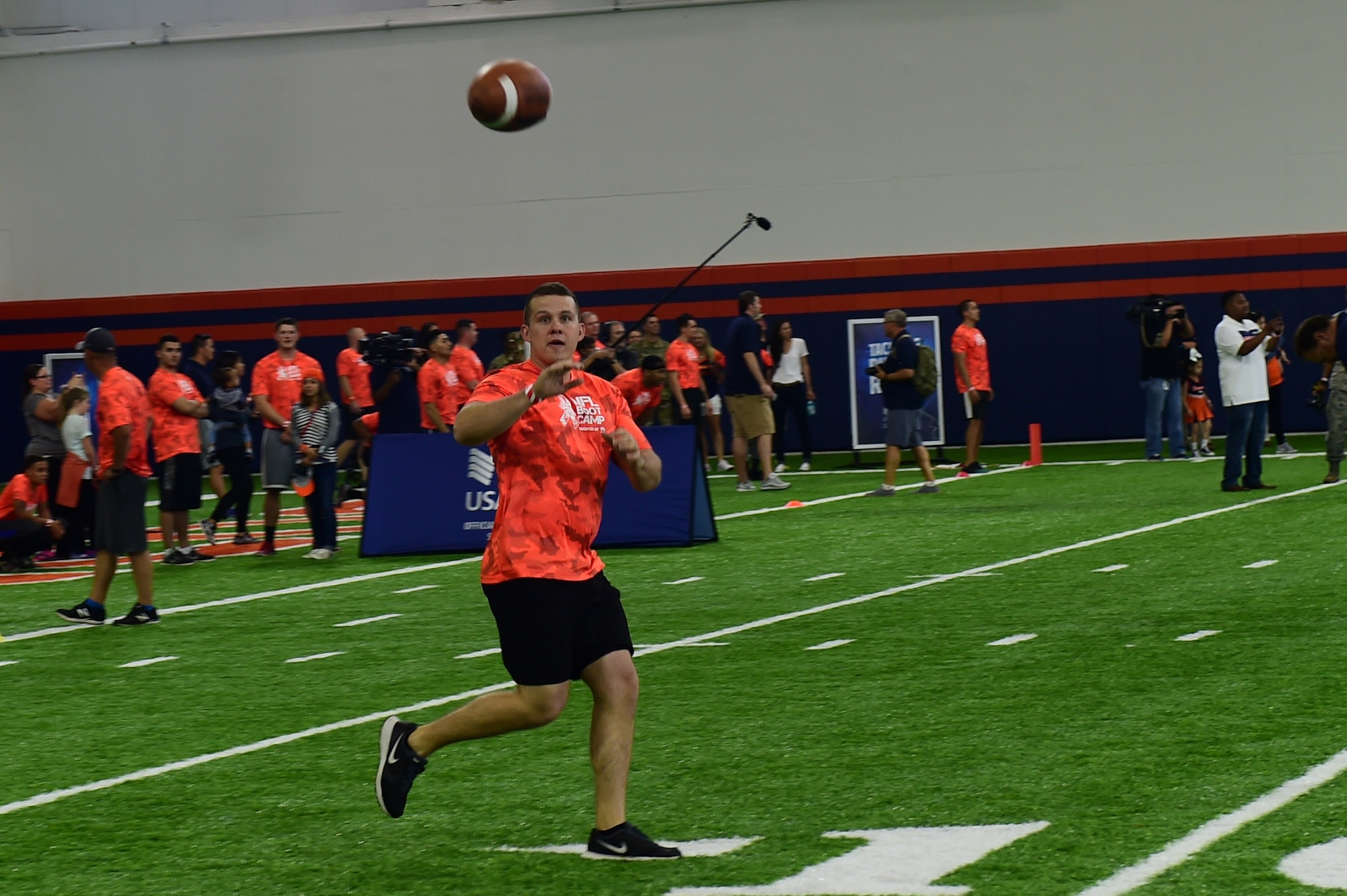 2nd Lt. Colin Wolff, 460th Space Wing space operations officer, catches a football during the team ball catching portion of a military training camp at the Denver Broncos’ University of Colorado Health Training Center Fieldhouse in Englewood, Colo., August 25, 2016.  Team Buckley won the military camp competition after participating in five head-to-head challenges including: team ball catching, a gauntlet, tackling dummy relay, sled push and the kneeling power ball launch. (U.S. Air Force photo by Airman 1st Class Gabrielle Spradling/Released)
