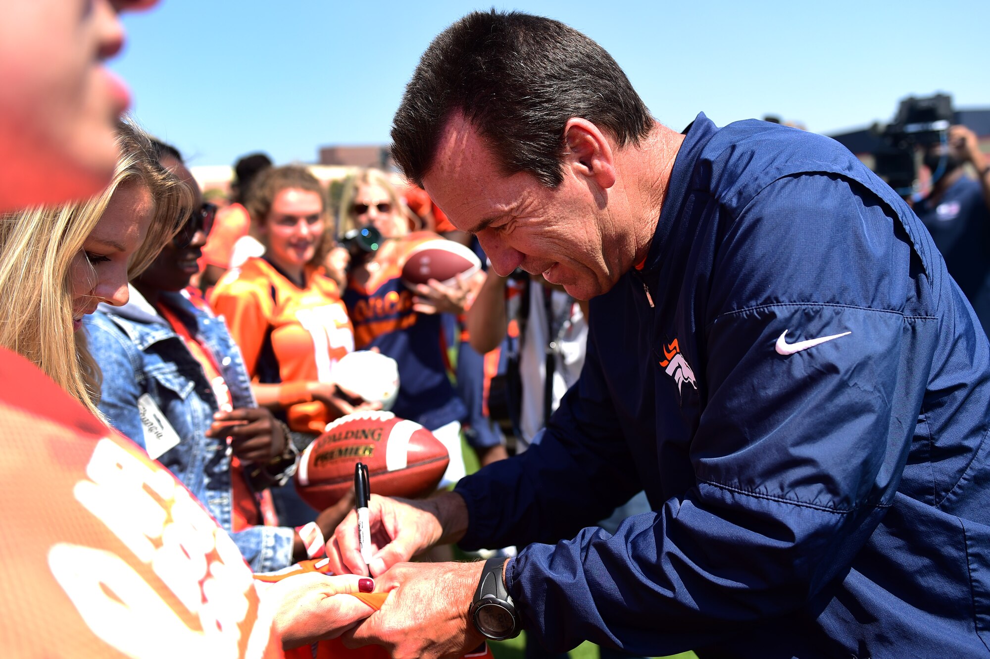 Gary Kubiak, Denver Broncos’ head coach, signs autographs during a military training camp at the Denver Broncos’ University of Colorado Health Training Center Fieldhouse in Englewood, Colo., August 25, 2016. The camp invited ten, five member teams to compete against each other and be a part of the NFL boot camp experience. (U.S. Air Force photo by Airman 1st Class Gabrielle Spradling/Released)