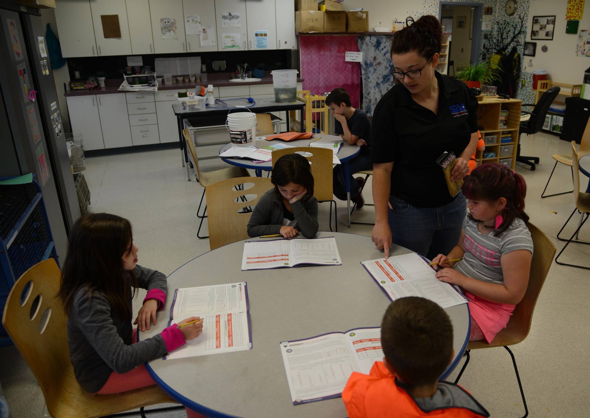 Beth Yost, Child and Youth program assistant at Ketchikan School Age Center, teaches children ratios and percentages following a game of Quickball Aug. 25. Quickball is a game that is part of the Science, Technology, Engineering and Math program at JBER’s school age centers and youth centers. STEM is an initiative under the Sea Research Foundation to promote student achievement and preparation for global competitiveness by fostering educational excellence and ensuring equal success. (U.S. Air Force photo by Staff Sgt. Wes Wright)