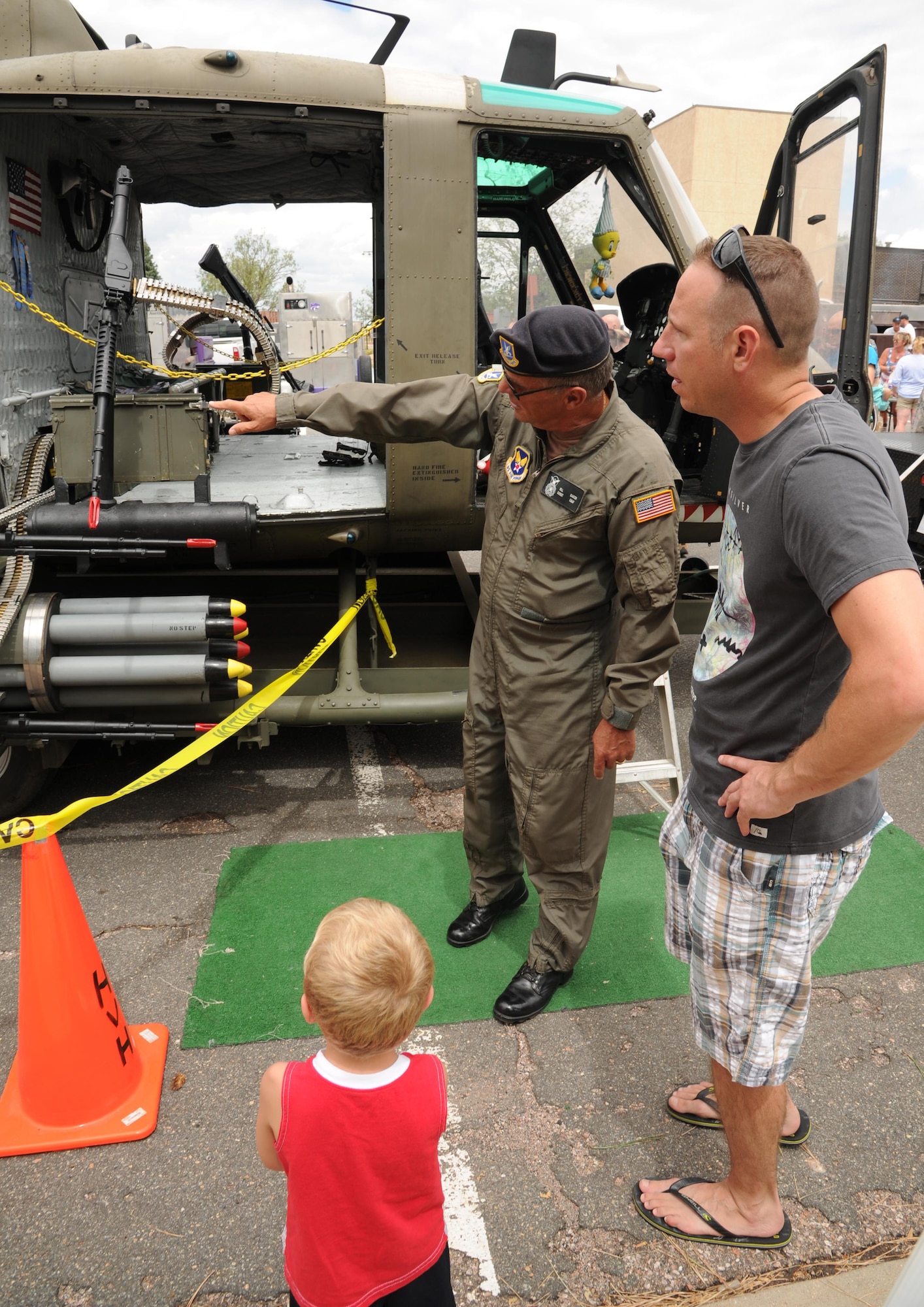 Master Sgt. Daniel Belk (right), 302nd Maintenance Squadron quality assurance, and his son, Daniel Lee Belk Jr. are given a tour of the UH-1 (M) ‘Huey’ by retired Chief Master Sgt. Bill Martin during the 302nd Airlift Wing Family Day on Aug. 6, 2016 here. During the August Unit Training Assembly, the 302nd AW honors families by hosting a family day for all wing members and their families. This year, there were a variety of activities in addition to the helicopter tours including bouncy houses, a fishpond, wheel of fortune, many tables with children’s games, and food for everyone. (U.S. Air Force photo/Staff Sgt. Amber Sorsek)