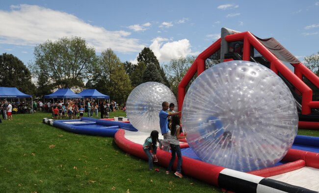 Children and adults line up to take a turn in the inflatable human hamster ball during the 302nd Airlift Wing Family Day on Aug. 6, 2016 here. This annual event allows wing members to show their appreciation to their families with an afternoon of fun during the August Unit Training Assembly. (U.S. Air Force photo/ Staff Sgt. Amber Sorsek)
