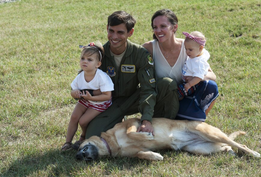 1st Lt. Stephen Dupuis, 69th Bomb Squadron aircrew member, poses for a photo with his family during a welcome home event at Minot Air Force Base, N.D., Aug. 23, 2016. This was one of the first rounds of deployment returns to Minot AFB in August 2016. (U.S. Air Force photo/Airman 1st Class Jonathan McElderry)
