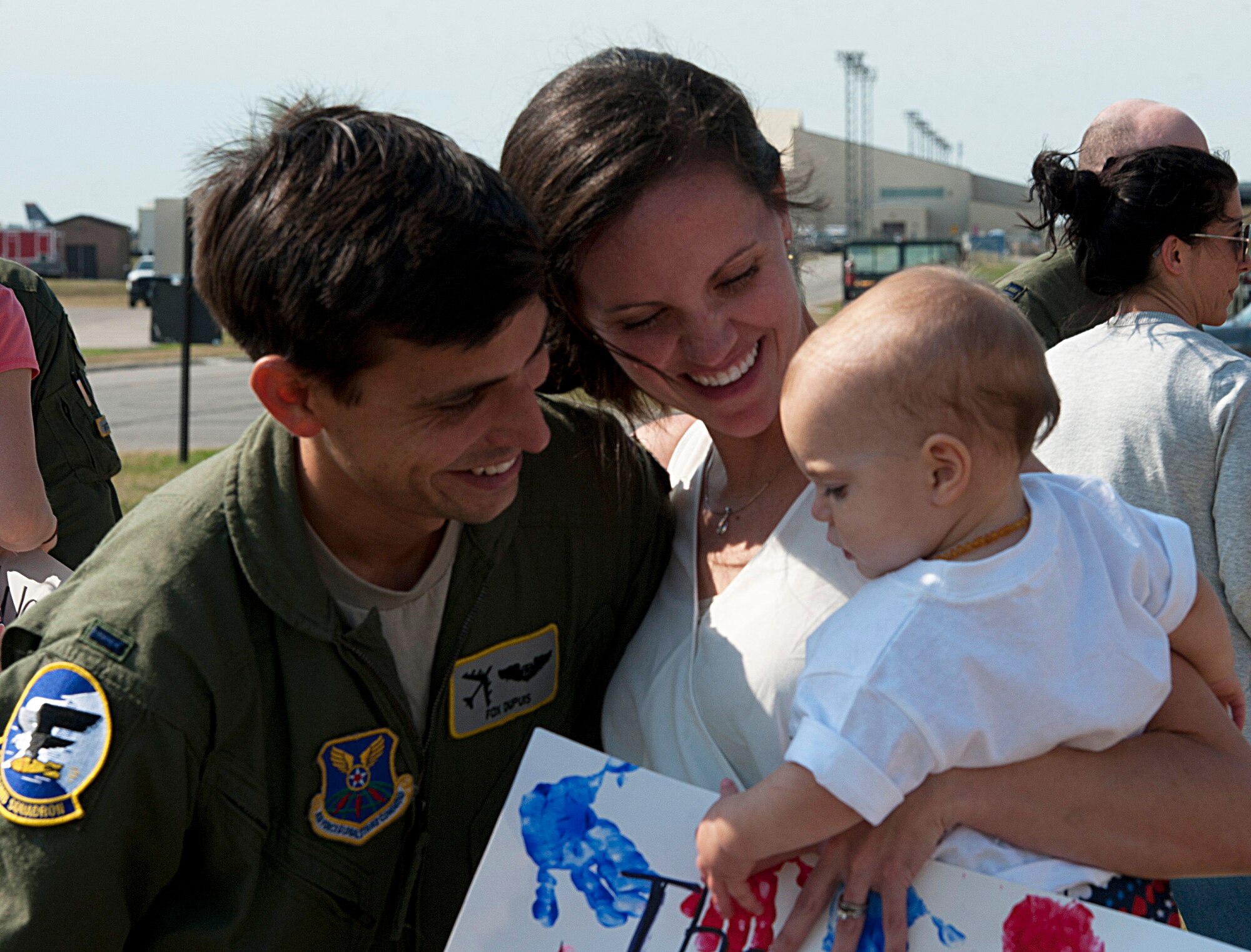 1st Lt. Stephen Dupuis, 69th Bomb Squadron aircrew member, greets his loved ones on the flight line at Minot Air Force Base, N.D., Aug. 23, 2016. This was the first time Dupuis has been back home with his family in six months. (U.S. Air Force photo/Airman 1st Class Jonathan McElderry)