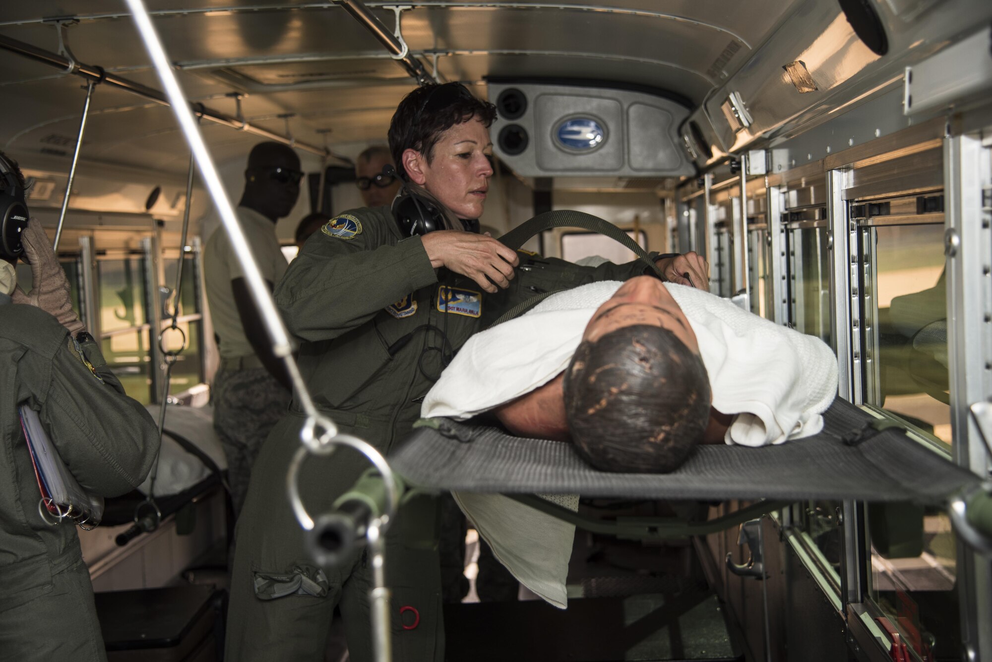 Tech. Sgt. Maria Ayala secures patients on a litter in a patient bus, preparing to transport onto C-130 Hercules during Patriot Warrior exercise August 16, 2016, at Fort McCoy, Wis. Patriot Warrior is the Air Force Reserve's premier contingency deployment training exercise, designed to demonstrate training ranging from bare base buildup to full operational capabilities. (U.S. Air Force photo by Staff Sgt. Adam C. Borgman)