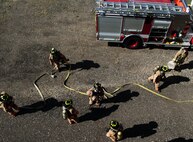 Firefighters with the 5th Civil Engineer Squadron begin separating into teams at the fire department training pit at Minot Air Force Base, N.D., Aug. 24, 2016. The unit prepares to deal with putting out class A fires, which have to be set in a specific location on base. (U.S. Air Force photo/Airman 1st Class Jonathan McElderry)